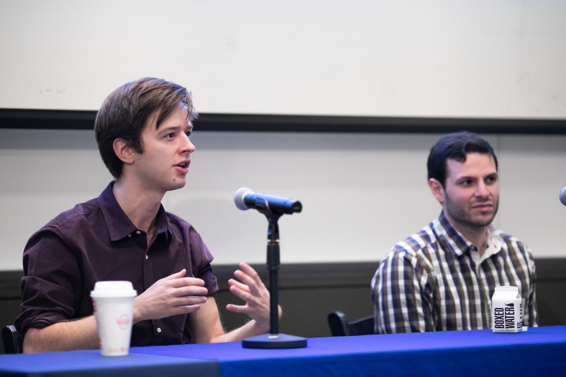 In the foreground, John Hewitt, assistant professor of computer science