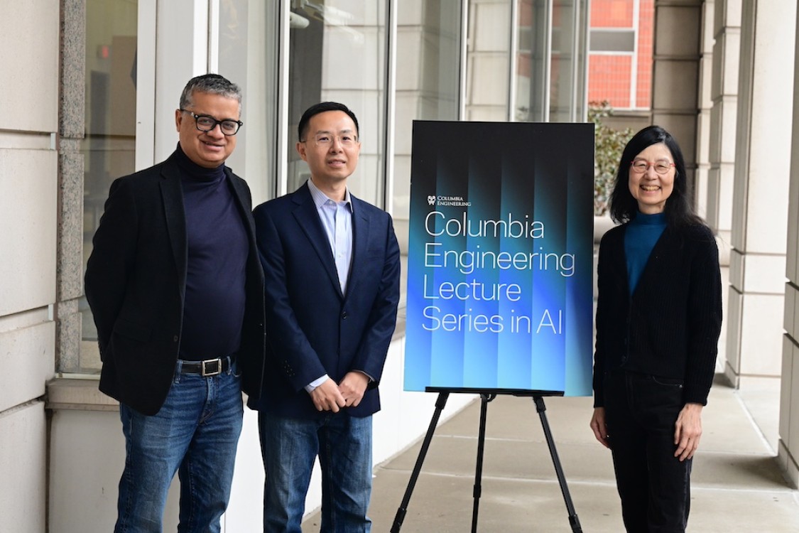 group photo with Jingren Zhou, standing next to Columbia Engineering banner